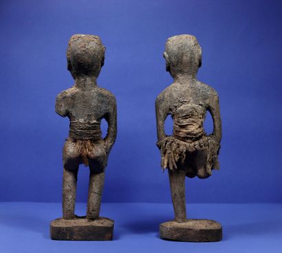 null 
Couple of wooden votive statues covered with a thick crusty material, the trunks...