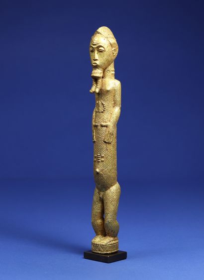  Elegant statuette representing a standing male figure, his short arms clasped to...