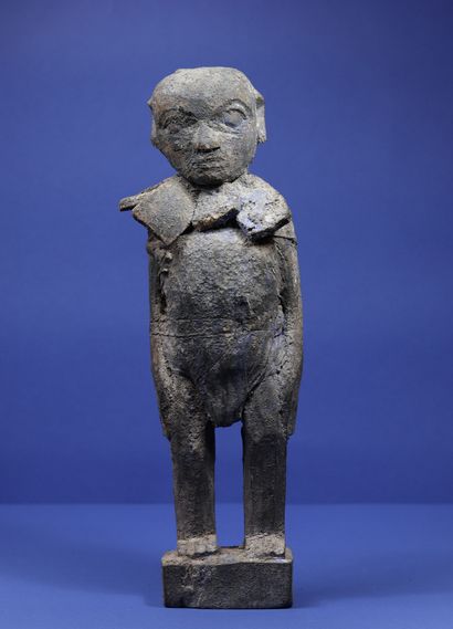 null 
Wooden statue representing a standing male figure wearing a necklace made of...