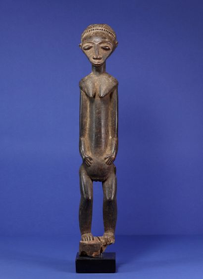  Beautiful long statue of a standing female figure, arms along the body, trunk extended,...