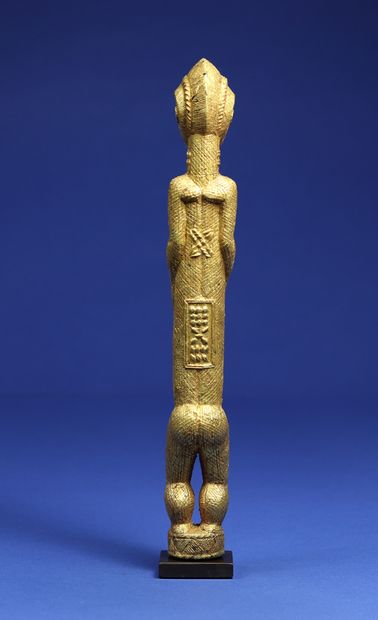 null 
Elegant statuette representing a standing male figure, his short arms clasped...