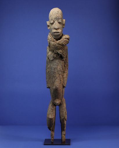  Important male statue wearing a cloth tied around the neck, in a standing position,...