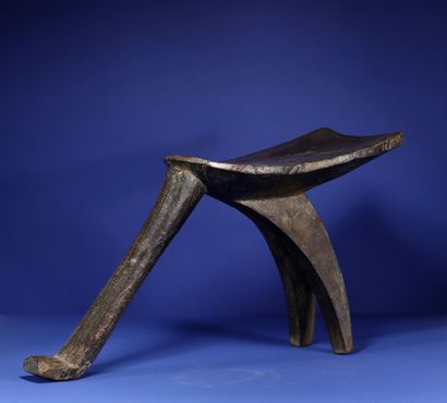  Tripod stool. Wood with a deep patina of use, iron clasp. Lobi, Burkina Faso. H....