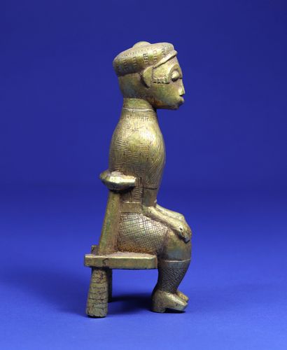 null 
Statuette representing a character sitting on a chair, dressed in European...