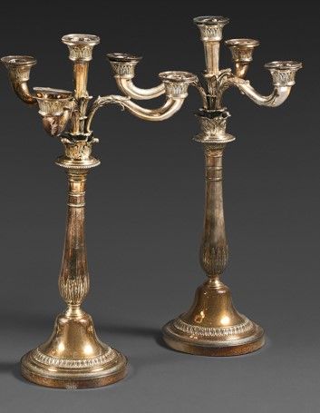  Pair of silver plated candelabras on a round base, the baluster shaft with three...