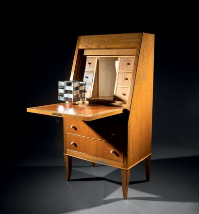 André ARBUS (1903-1969) A sycamore veneered desk with a full flap opening onto a...