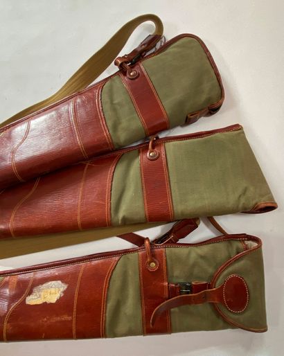null Three green and brown canvas and leather rifle cases. Wear, tears.