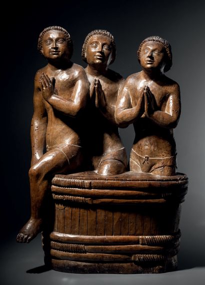 Three children in a walnut salter carved...