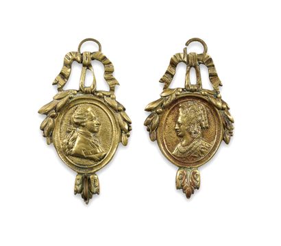 Pair of gilt bronze watchholders with profiles...