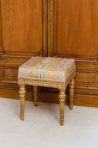 null Stool in molded wood, carved and gilded with friezes of water leaves, dices...