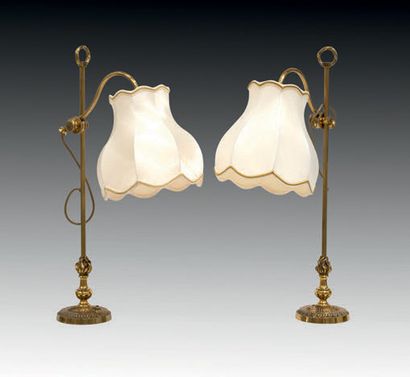 null Two gilt metal bedside lamps, with pivoting arms, the central fluted shaft topped...