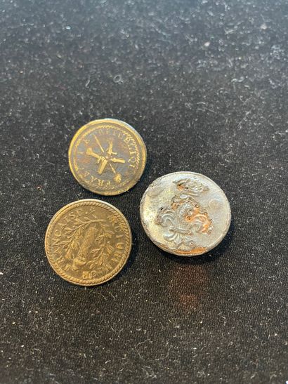Three military buttons :
Two large brass...