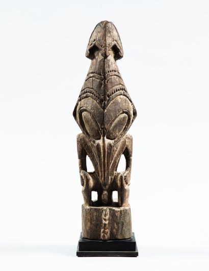 Garamut drum end decorated with a figure
Bas...