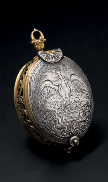 null Montre ovale en argent et laiton, ciselés, gravés et dorés. Faces en argent,...