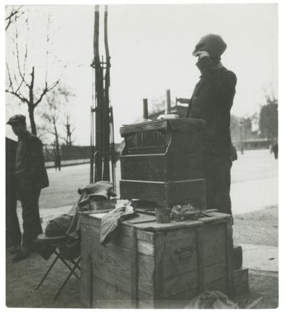 GERMAINE KRULL (1897-1985) Organ grinder Paris,1930 Vintage gelatin silver print,...