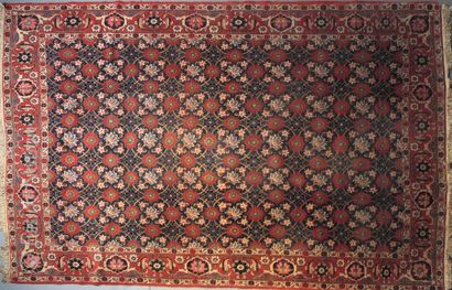 TAPIS. ORIENT Woollen rug with polychrome decoration of flowers in blue crosses....
