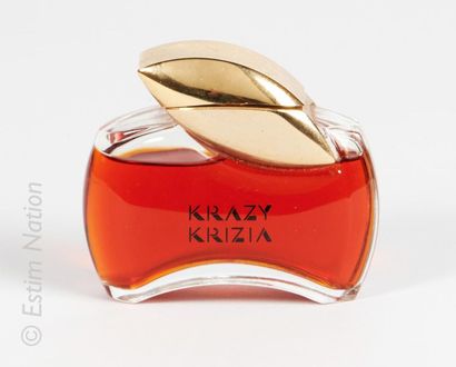 KRIZIA « Krazy » Glass bottle titled on one side "Krazy Krizia". Golden stopper containing...