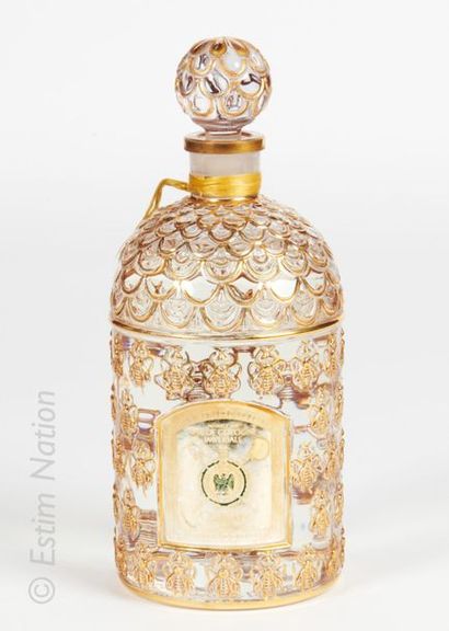 GUERLAIN « Eau de Cologne Impériale » Colourless pressed moulded glass bottle, gold-coloured...