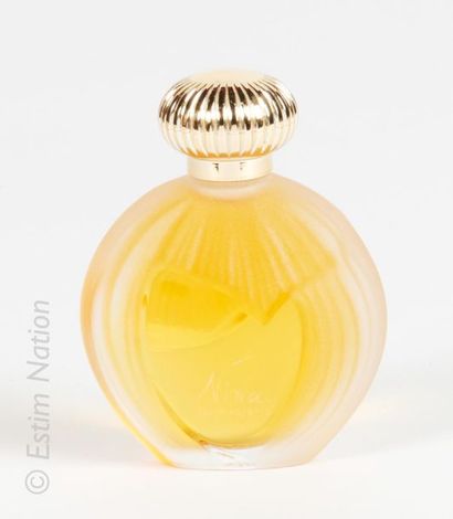 NINA RICCI « Nina » Glass bottle with rounded shape, decorated in relief on both...