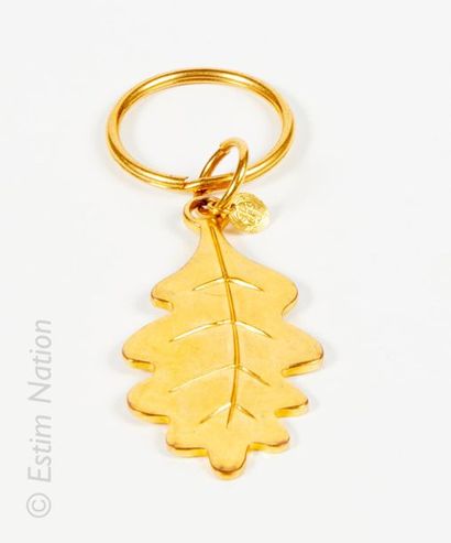 Inès de LA FRESSANGE Keychain featuring a golden oak leaf.
Small medallion logo Inès...