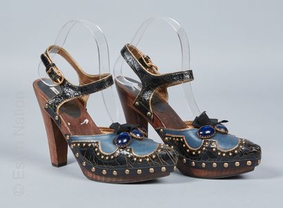 MIU MIU PAIR OF SANDALS inspired clogs in cracked black leather with blue cabochons...