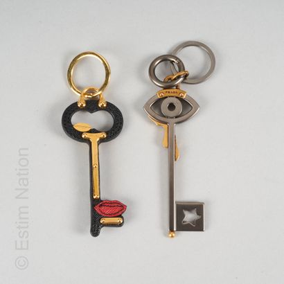 PRADA DEUX BIJOUX DE SAC "clés" : le premier en métal et cuir, le second orné d'une...