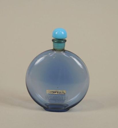 WORTH "Je reviens" (1932)

Flacon modèle médaillon en verre teinté bleu avec son...