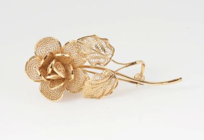 BROCHE EN ROSE Broche en métal doré filigrané formant une rose au naturel. Long:...