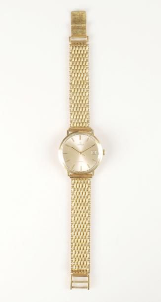 OMEGA Montre bracelet d'homme. Le boitier en or jaune 18K (750°/00). Le cadran irisé,...