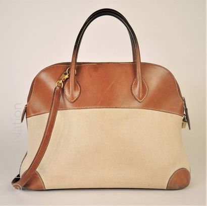 HERMES Paris SAC "BOLIDE" en cuir gold et toile "H", cadenas, deux clés sous clochette,...