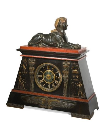 null Pendule en bronze patiné, marbre noir et rouge griotte à décor d'un Sphinx couché...