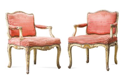 null Pair of wooden armchairs carved, molded and painted with exploded shells. Armrests...