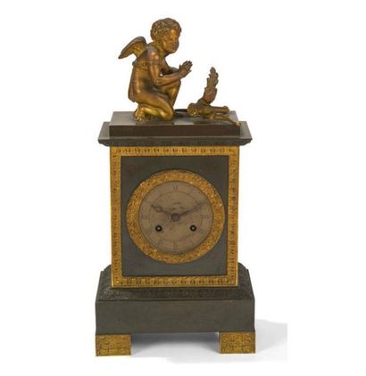 null A gilded and patinated bronze clock surmounted by a cupid with a quiver, a torch...
