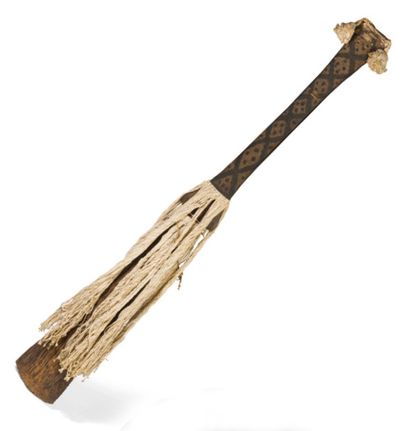 null Wooden club of flared shape with a handle covered with a wickerwork weave with...