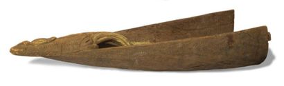 Front of a dugout canoe carved with a mask...