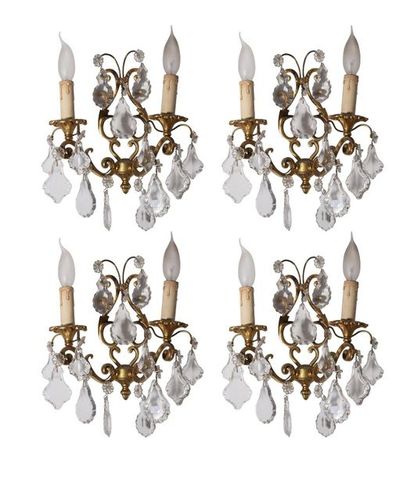 null A suite of four two-light metal sconces holding cut crystal pendants.
H. 27...