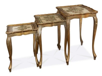 null A suite of three nesting tables in moulded, lacquered and gilded wood with incised...