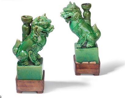 null - Pair of lions forming candlesticks in green glazed ceramic, the lions shown...