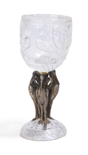 null - Moulded crystal glass with mask decorations. The chased bronze base with three...