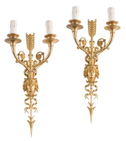  Pair of two-light wall lights in chased and gilded bronze with profiles, arrows...