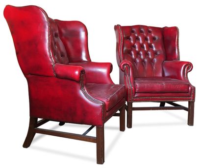 null Pair of red studded leather armchairs, Chesterfield wing back and cushioned...