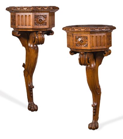 null Pair of carved, moulded and patinated wooden consoles. The gadrooned belt with...