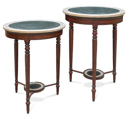  Pair of pedestal tables in mahogany and mahogany veneer. They stand on three tapered...
