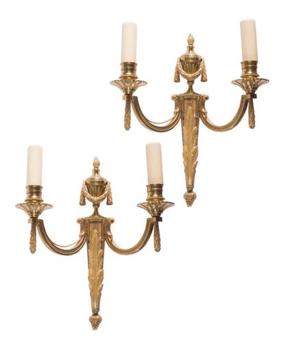  Pair of chased and gilded bronze two-light sconces decorated with urns, foliage...