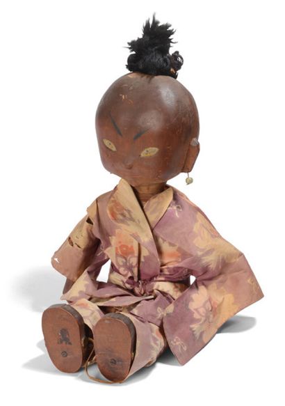 null Painted and patinated articulated wooden doll and polychrome silk kimono
Indochina....