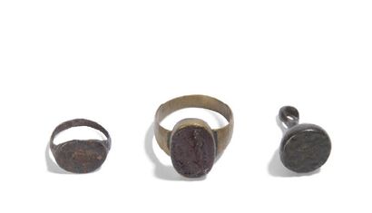 null Set including:
- A metal signet ring with trace of engraving
- A copper seal...