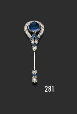 null Platinum and 18K (750) white gold jabot pin set with a sugar loaf cabochon sapphire,...