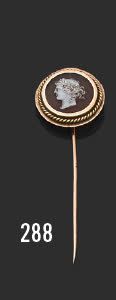 null A yellow gold (750) tie pin with a round cameo carved with a carved profile...
