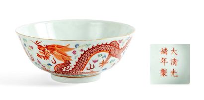 null A porcelain and green family enamel bowl decorated with two dragons chasing...