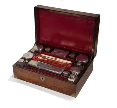 null Travelling toiletry set, the box in burr veneer and brass mounts. It includes...